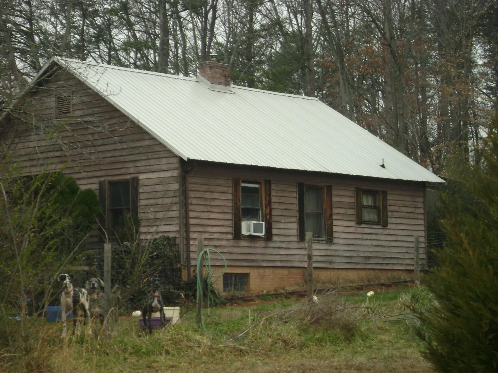 White metal roof on an old wood sided farmhouse, from a Metal Roof Installation job in Hoschton